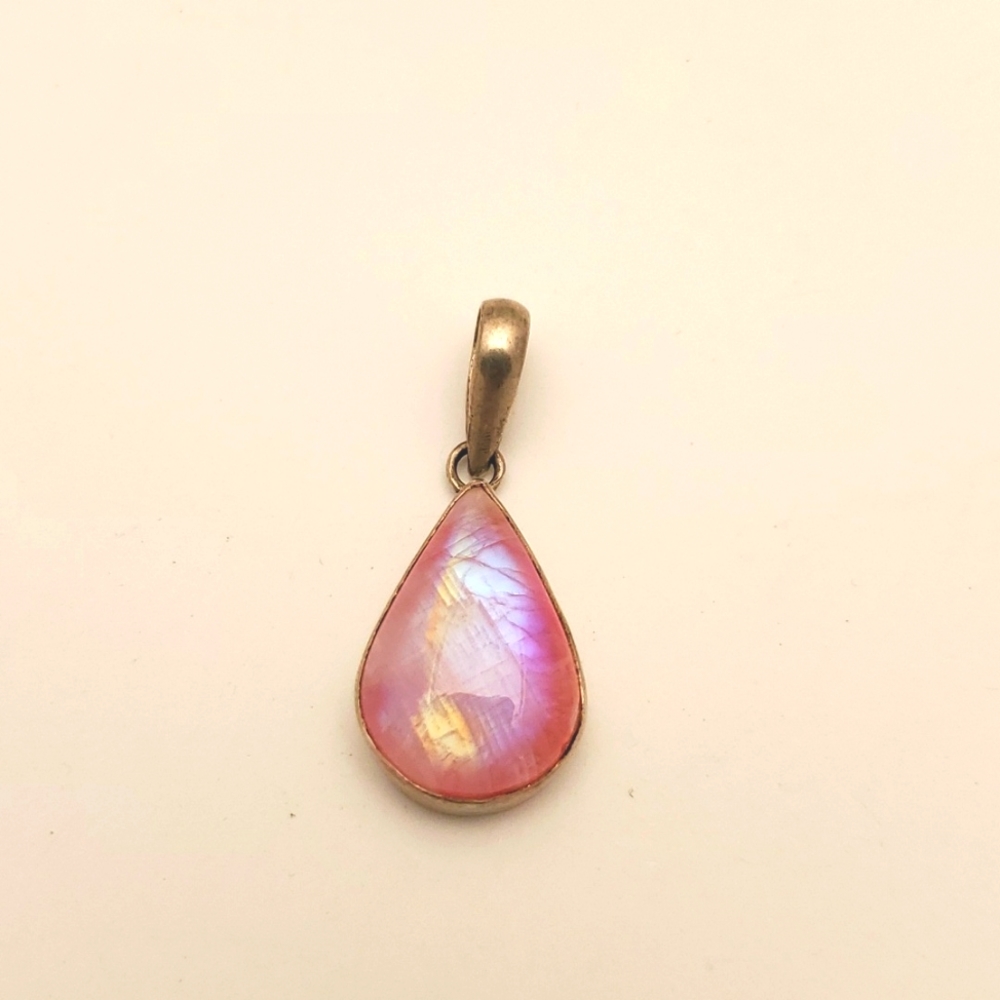Pink stone pendant in a silver tone bezel